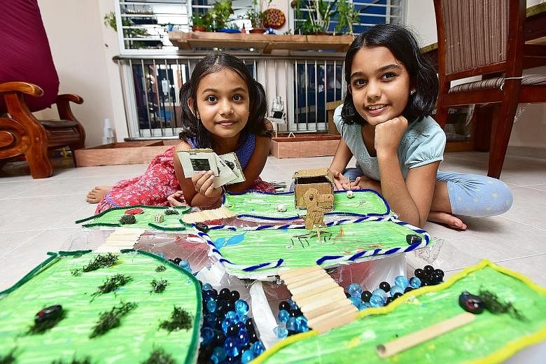 Sophia (left) and Anjali with the board game Sophia built for the Maker Faire. Anjali built a story garden depicting scenes from popular fairy tales. They were the youngest participants.