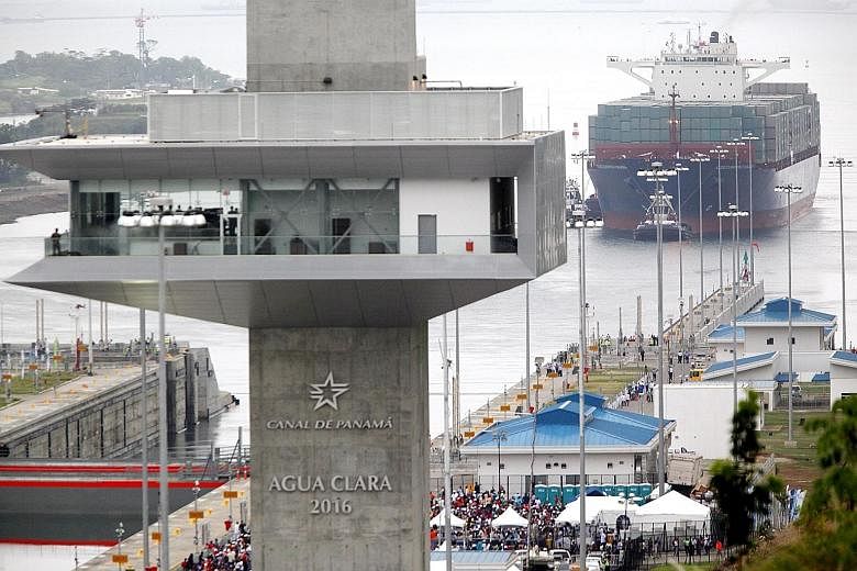 The Chinese container ship Cosco Shipping Panama making the inaugural transit through the Agua Clara floodgate of the newly expanded Panama Canal yesterday.