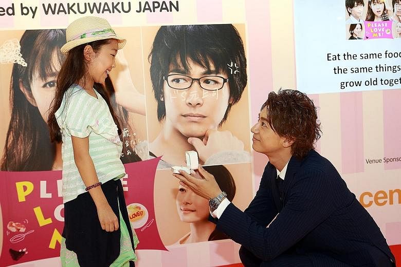 Actor Shohei Miura re-enacts a marriage proposal scene from his TV series, Please Love Me!, with a young fan.