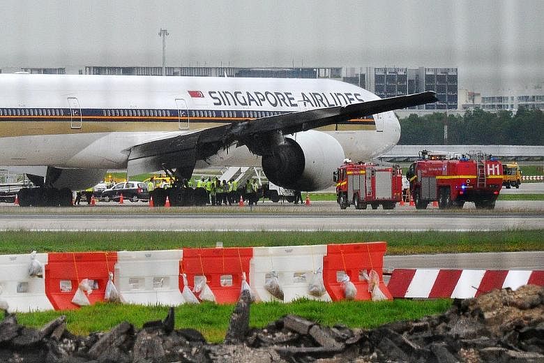 Above: The blackened wing of Flight SQ368 after the fire was put out. None of the passengers and crew were hurt. Left: The blaze was quite fierce, said passenger Lee Bee Yee. "The SQ crew were very professional in calming everyone down."