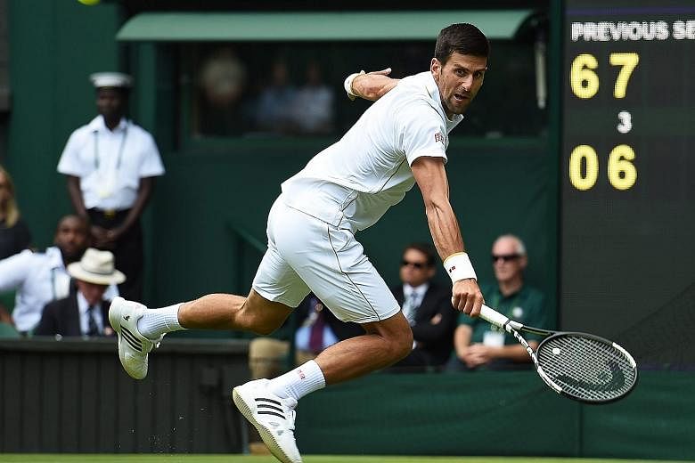 Wimbledon defending champion Novak Djokovic hitting a return to Britain's James Ward during their Wimbledon first round match at the All England Club. The Serb won in straight sets to keep alive his hopes of claiming a calendar Grand Slam, and will n