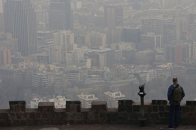 Smog blanketing buildings in the Chilean capital Santiago this month. The IEA says that without action, premature deaths attributable to outdoor air pollution will increase to 4.5 million in 2040, from about three million now. Asia will account for a