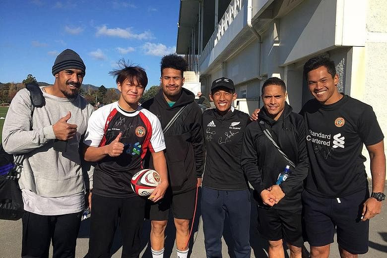 Marcus Ng (second from left) and Muhammad Nur Solihin Mansor (third from right) had a chance to meet All Blacks (from left) Jerome Kaino, Mardie Savea, and Aaron Smith during their training stint in Wellington. At right is SRU senior rugby developmen