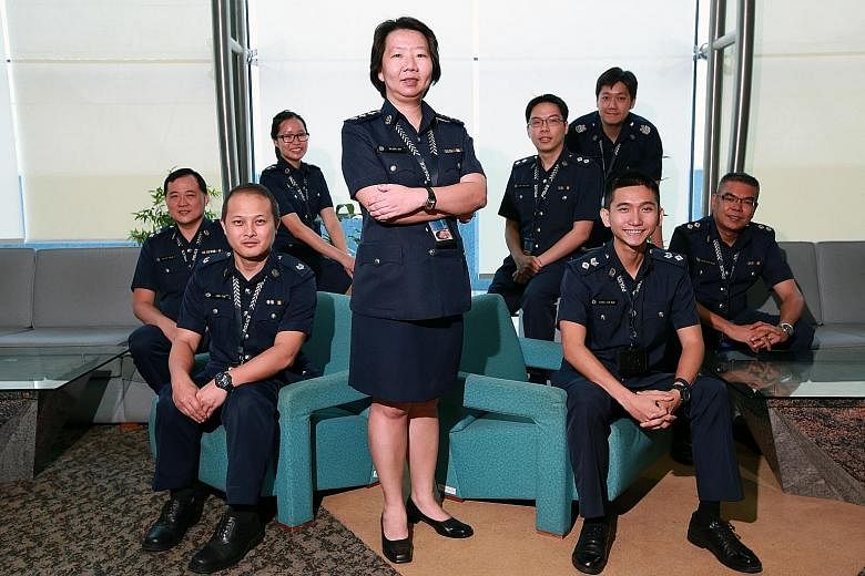 Among those commended at a police ceremony yesterday were Supt Yap (standing), the leader of the team in charge of the Jover Chew case. Members of her team included (from left) Deputy Superintendent Tan Sin Choon, 45; Assistant Superintendent Andy Ta