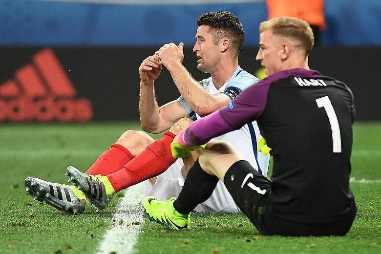 Gary Cahill and Joe Hart are completely floored after England's capitulation in the round of 16. Both had failed to cover themselves in glory against Iceland, as a slew of defensive errors contributed to their exit.