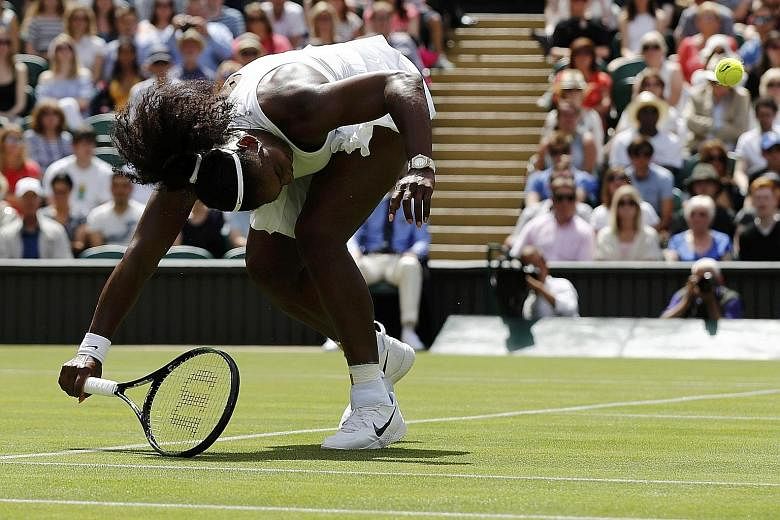 Serena Williams returning against Switzerland's Amra Sadikovic. The American endured a poor service game with five double faults and only four aces to win in straight sets and progress to the second round at the All England Club.