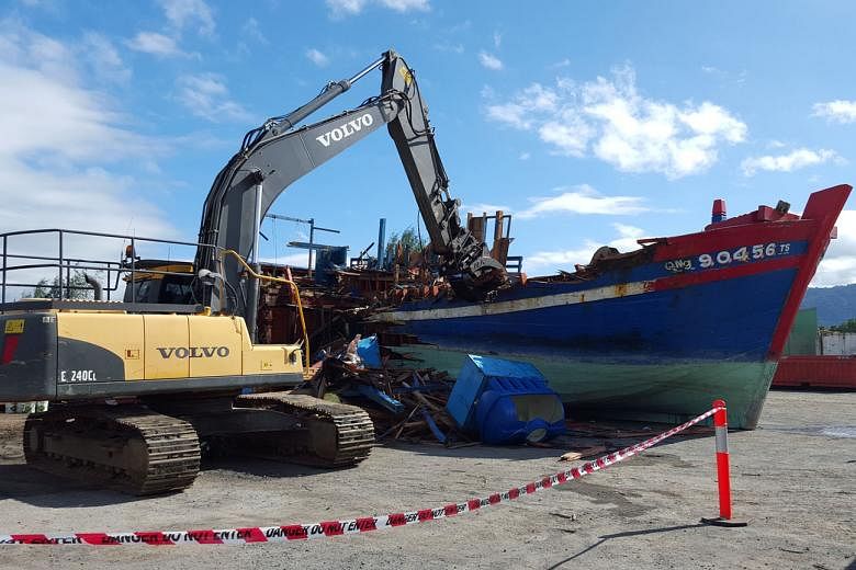 A boat seized from Vietnamese seamen fishing illegally in protected waters being destroyed in Cairns. Stepped-up surveillance by Australia has seen the amount of illegal fishing fall sharply from a decade ago. 