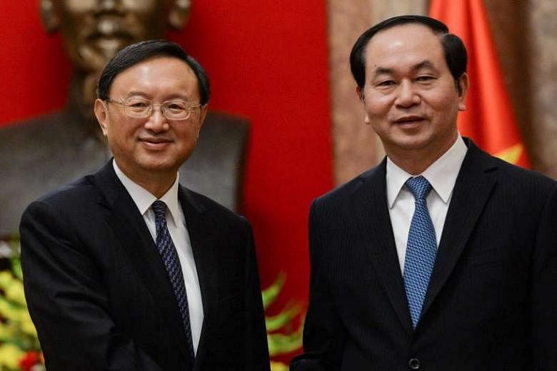 Chinese State Councillor Yang Jiechi (left) with Vietnamese President Tran Dai Quang yesterday. Mr Yang's visit is aimed at strengthening relations at a time when ties are strained amid squabbles over the South China Sea. 