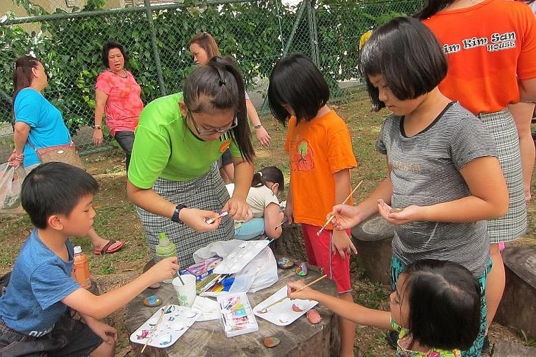 Woodlands residents learning how to grow their own vegetables, make herbal tea, paint on pebbles and create eco-craft items at an event organised by students of Evergreen Secondary School on March 12.