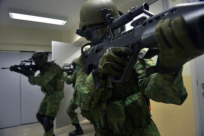 Soldiers from the 1st Commando Battalion demonstrating urban operation techniques at the Commando Training Institute in Pasir Ris Camp. The Best Unit award takes into account factors like training safety standards.