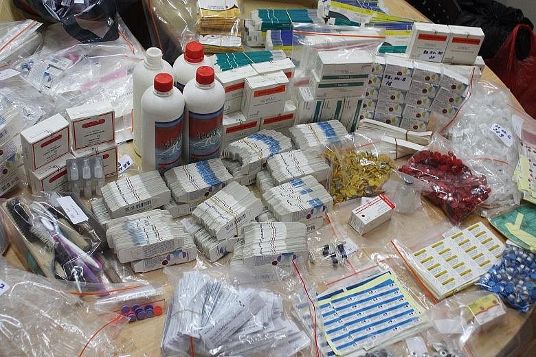 Fake vaccines displayed by the Criminal Investigation Agency of Indonesia's National Police at the police headquarters in Jakarta last week. Police have smashed a syndicate accused of selling fake vaccines for more than a decade to health clinics acr
