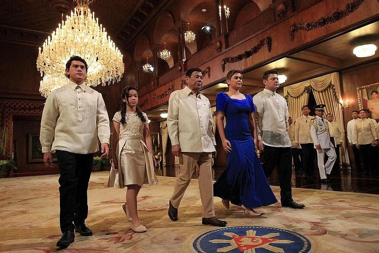 Philippine President Rodrigo Duterte with his children - (from left) Sebastian, Veronica, Sara and Paolo - after the oath-taking ceremony at the Malacanang Palace in Manila yesterday. Veronica, 12, held the Bible of the President's mother, Soledad, w