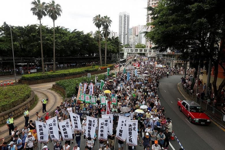 Pro-democracy protesters marching in Hong Kong yesterday, on the 19th anniversary of Hong Kong's return to Chinese rule.