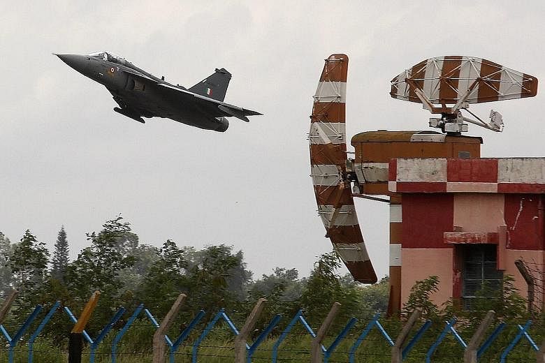 A Tejas jet taking off for an aerial display in Bangalore yesterday as the first two of the India-made jets were inducted into the country's air force after years of delay.