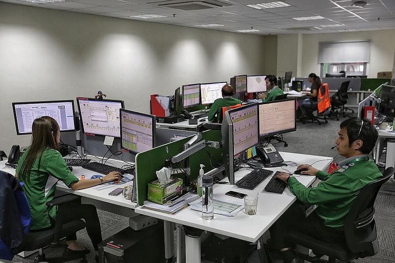 Service controllers at the Bulim bus depot operating LTA's new Common Fleet Management System. Tower Transit is the first here to use the system, which tracks buses in real time, and ensures that waiting times are kept as consistent as possible.
