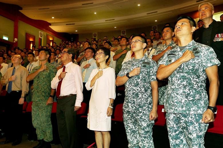 Minister for Culture, Community and Youth Grace Fu reciting the pledge at the SAF Day combined rededication ceremony at the Singapore Institute of Technology, together with its president, Professor Tan Thiam Soon (third from left) and Chief of Navy R