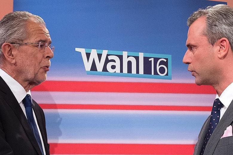 Austrian presidential candidates Alexander van der Bellen (far left) and Norbert Hofer at a TV discussion in May. Mr Van der Bellen won the election, but a legal challenge by Mr Hofer's far-right Freedom Party saw the Constitutional Court annul the r