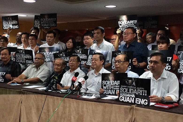 DAP leaders, together with secretary- general Lim Guan Eng (front row, third from right) were defiant at their leadership meeting yesterday, repeating their stand that the two corruption charges against Lim and a businesswoman were trumped up by the 