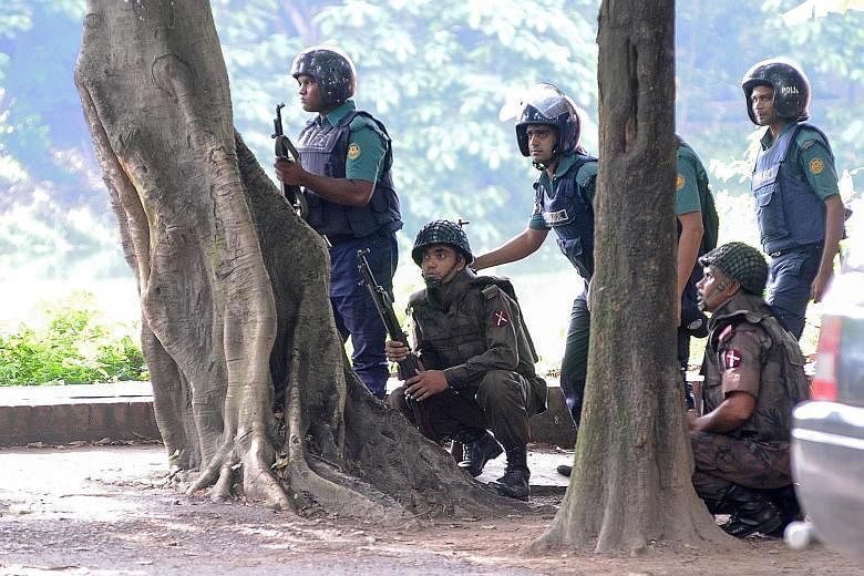 Soldiers taking up their positions near the Holey Artisan Bakery yesterday, after militants embarked on a killing spree at the upscale cafe in Dhaka on Friday night. The attack took place in the Gulshan neighbourhood, which is home to the country's e