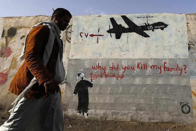 Graffiti on a wall in Sanaa, Yemen, denounces strikes by US drones. US President Barack Obama, to whom the drone programme is personal and a defining feature of his presidency, has issued an executive order making civilian protection a priority and r