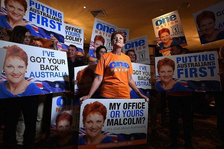 Ms Hanson with supporters at a function on election night in the city of Ipswich, Australia, on Saturday. She has largely shifted her focus from attacking Asian migrants to criticising Islam. But she wants to restrict overall migration.