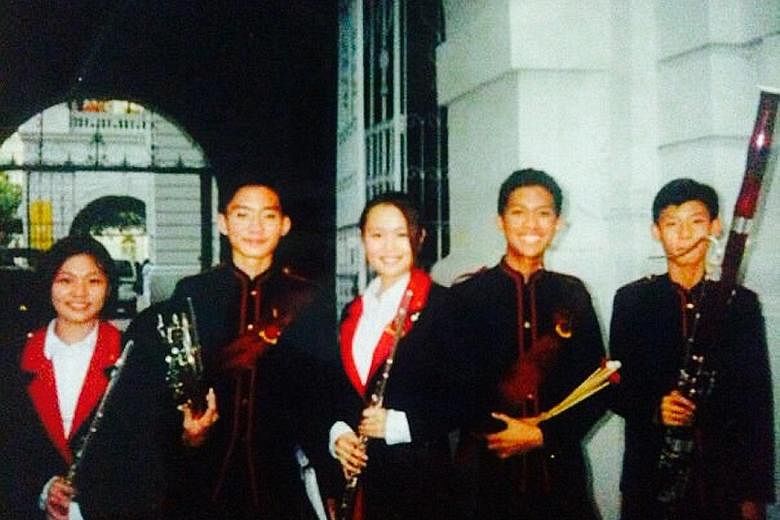 Mr Alfri (second from right) with fellow members of Junyuan Secondary School band after their SYF performance in 2003. This picture was taken outside the Victoria Theatre and Concert Hall.