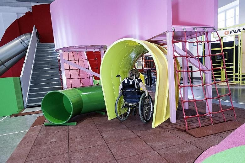 A young wheelchair user taking part in an obstacle course at the MegaMind science centre in Sweden's National Museum of Science and Technology.