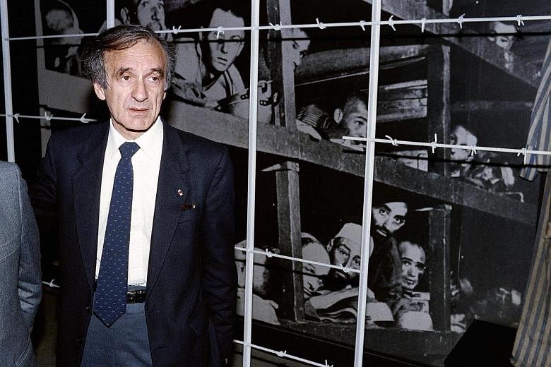 Mr Wiesel in front of a photo of himself (bottom, third from right) and other inmates at the Buchenwald concentration camp in 1945, during his visit to the Holocaust Memorial Centre in Jerusalem in 1986.