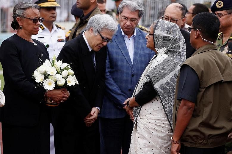 Prime Minister Sheikh Hasina talks to Japan's Ambassador to Bangladesh Masato Watanabe after paying homage to those killed. Among the victims were seven Japanese. Relatives carrying the coffin of one of those killed in last Friday's cafe attack in Dh