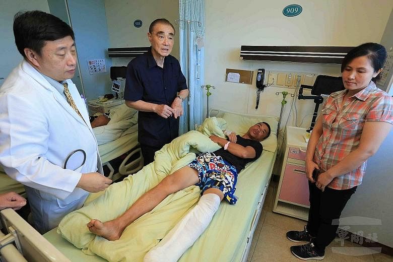 A fisherman injured by the misfired navy missile receiving a visit from Taiwanese Defence Minister Feng Shih-kuan (second from left) at a hospital in Kaohsiung at the weekend. Mr Feng apologised for the incident and promised to tighten discipline and