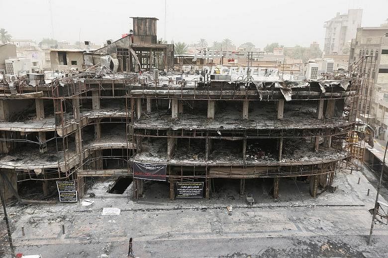 The site of a suicide bomb attack in the shopping area of Karrada in Baghdad on Sunday which killed at least 213 people, one of three major attacks linked to ISIS in the past week. It follows a deadly cafe siege last Friday in Dhaka in which 20 hosta