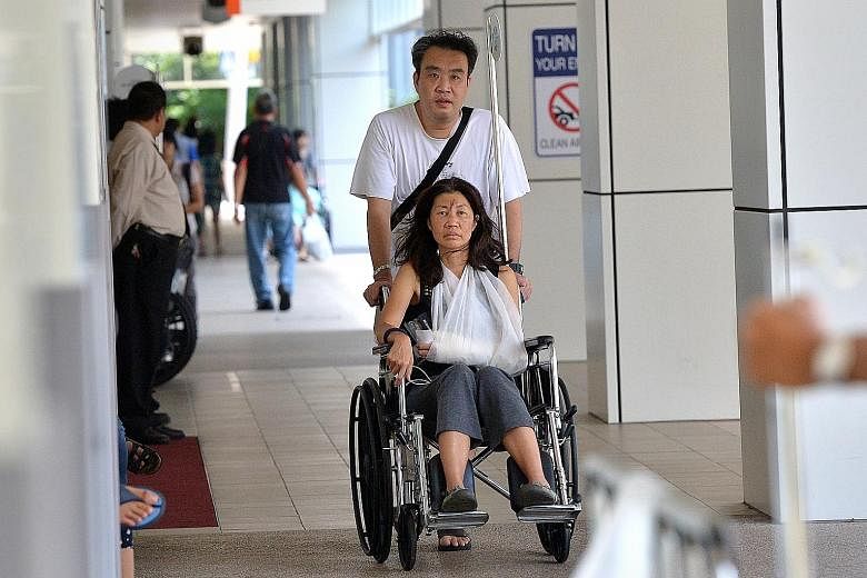 (Above)  Madam Chua in a wheelchair at National University Hospital yesterday. She was there for treatment.