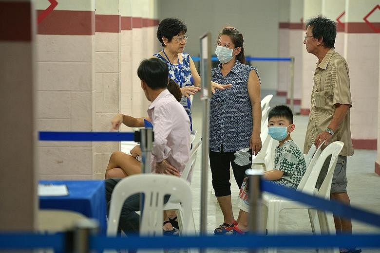 Residents of Block 203, Ang Mo Kio Avenue 3, getting screened for tuberculosis last month. Many seniors happen to live in the block where the discovery of a highly unusual cluster of six drug-resistant TB cases triggered the screening exercise.