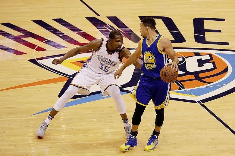 Golden State's Stephen Curry (right) and Oklahoma City's Kevin Durant facing off in Game 3 of the Western Conference Finals. The former rivals will become team-mates after Durant signed a two-year deal worth US$54.3 million (S$73.2 million).