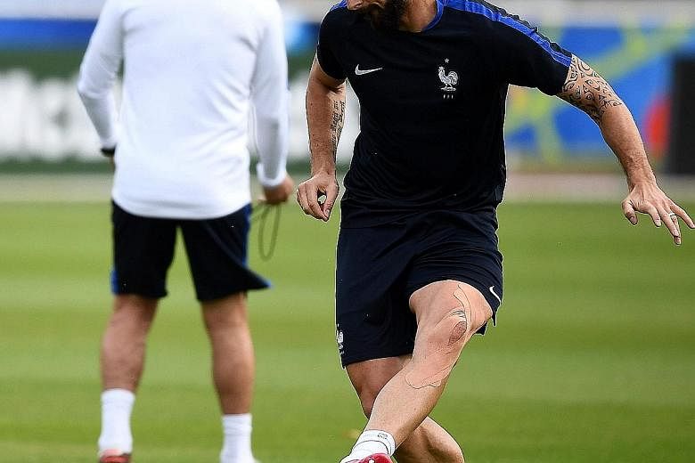 Above: In-form France forward Olivier Giroud at a training session last week. He has a fine recent record for his country and club Arsenal against Germany and Bayern Munich custodian Manuel Neuer. Right: France coach Didier Deschamps with midfielder 