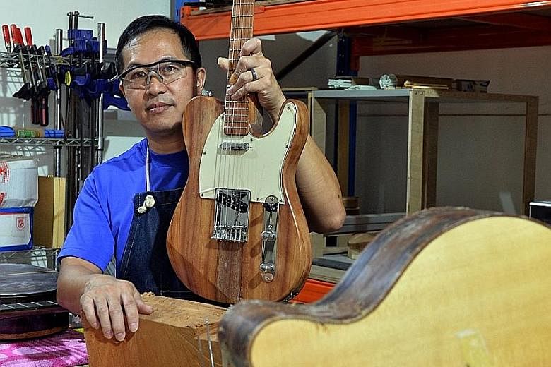 Mr Chan with the electric guitar he made from a 25m-tall Senegal mahogany tree that once stood next to the F1 Pit Building at Marina Promenade. The tree-lover feels that having a "tangible" and "cool" object will help spread the conservation message 
