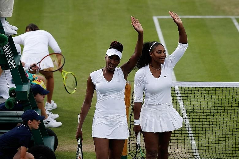 Serena (right) and sister Venus waving after defeating Slovenia's Andreja Klepac and Katarina Srebotnik 7-5, 6-3 in their Wimbledon doubles first-round match. Two more wins later, they are in the last eight.
