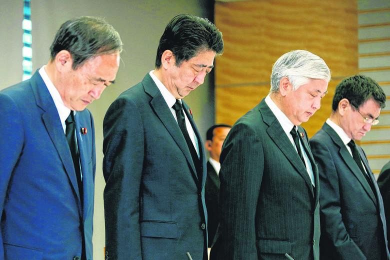 (From far left) Japan's Chief Cabinet Secretary Yoshihide Suga, Prime Minister Shinzo Abe, Defence Minister Gen Nakatani and National Public Safety Commission chairman Taro Kono observing a minute of silence on Tuesday for the victims of the Dhaka at