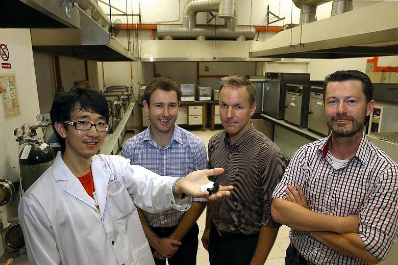 Research fellow Yu Yi Fu (far left), 30, shows a sample of CFA, a product that could make industrial waste management cheaper and more eco-friendly. With him are (from left) EcoWorth Tech programme manager Kim Wimbush, chief operating officer Andre S