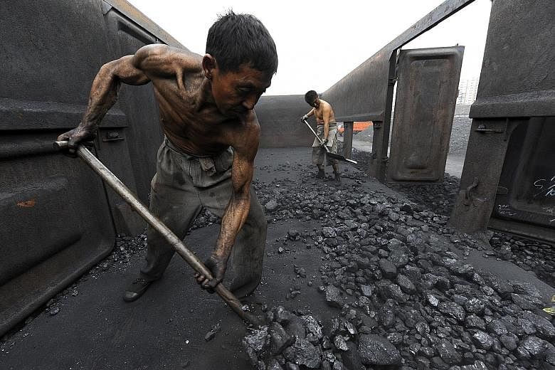 Workers unloading coal in Hefei, in China's Anhui province. Figures show that in 2012, China used the most coal: 47 per cent of the global total. Increased coal use in Asia could cause widespread cooling of the Northern Hemisphere, which could lead t