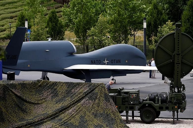 A Nato unmanned drone on display at an exhibition in Warsaw on Wednesday. In response to what is deemed a more aggressive Russian attitude to Europe, Nato nations are set to agree at today's summit on the deployment of four battalions to the Baltic s