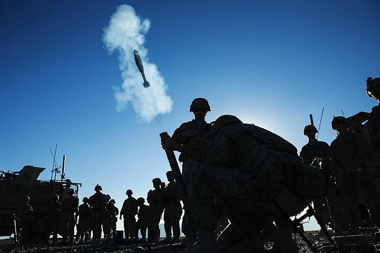 US soldiers conducting a mortar exercise in Afghanistan. American troops will remain in the country for some time still, said Mr Obama, as Afghan forces are still not strong enough to tackle the precarious security situation.