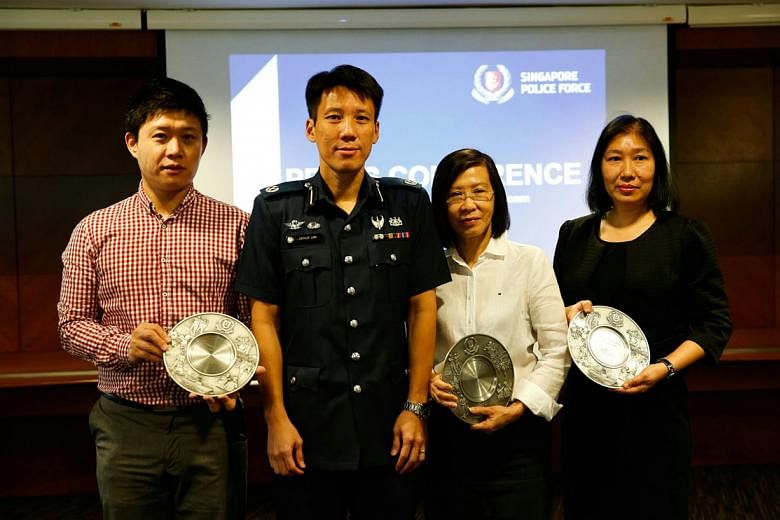 Deputy Assistant Commissioner of Police Arthur Law with Mr Li, Ms Thng and Ms Clara Ling yesterday. Ms Ling collected the Public Spiritedness Award on behalf of Ms Han. 