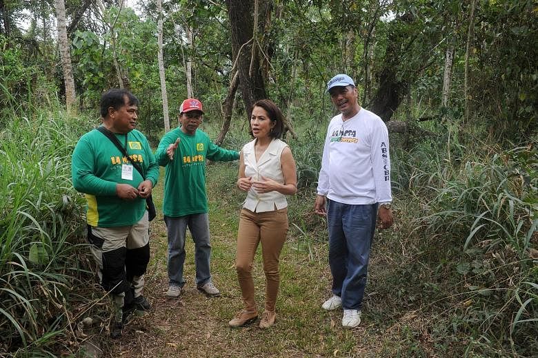 Ms Lopez inspecting a tropical rainforest that has regrown on the edge of Manila's biggest open-air dump, in February last year. The environment chief is spearheading tougher regulation of the resources sector.