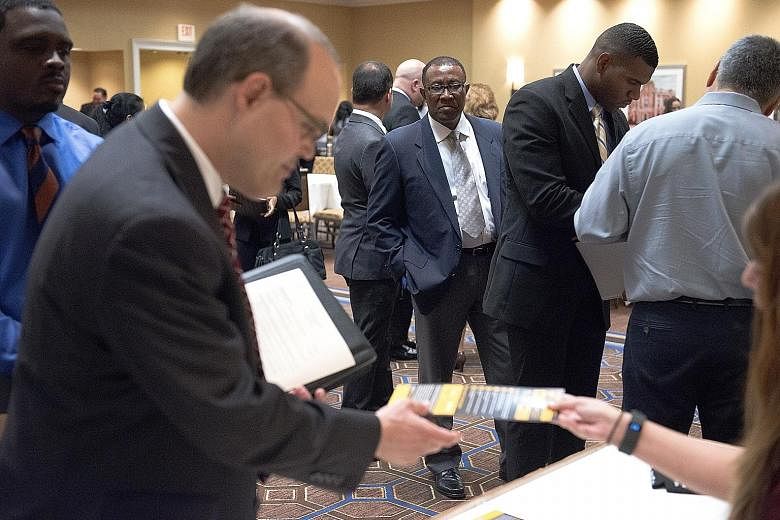 Job seekers at a career fair in Houston, Texas, on Thursday. The US leisure and hospitality sector added 59,000 jobs, registering the biggest gain since February last year. But, overall, wages advanced less than projected.