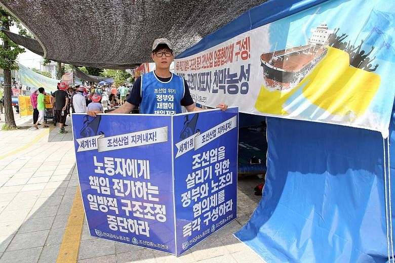 Mr Park, a shipyard electrician, has been protesting against the shipping crisis in front of South Korea's Parliament House since June 26. His sign calls for responsibility towards shipbuilding union members.