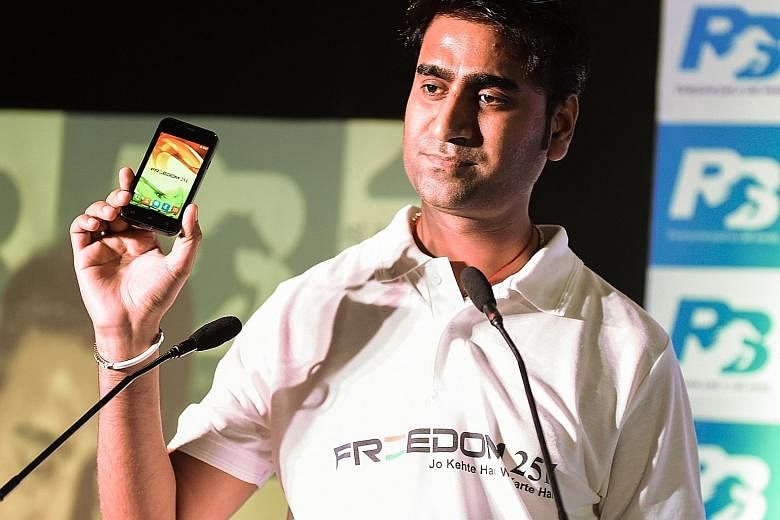 Ringing Bells' Mr Goel with the Freedom 251 at a media event in New Delhi on Thursday.
