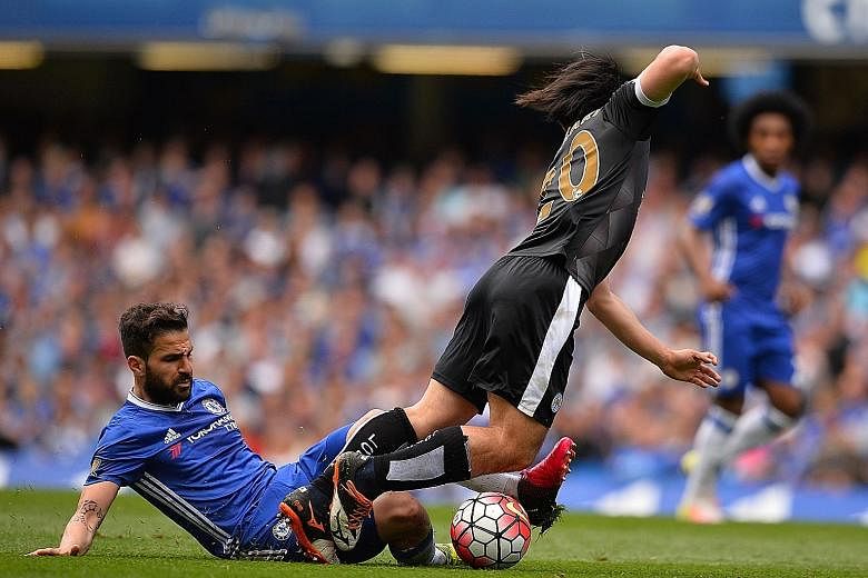Cesc Fabregas tackling Leicester's Shinji Okazaki during the final Premier League match last season. The Spaniard will need to show he can take on more battles in midfield if he is to win the fight to be a regular for new Chelsea manager Antonio Cont