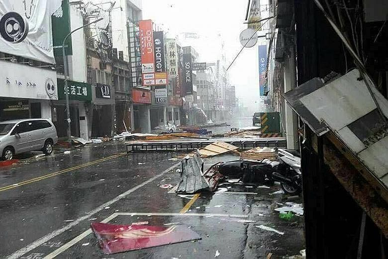 Several Singaporeans in Taiwan have been forced to change their travel plans as the super typhoon made landfall. It tore into Kaohsiung (above) and Tainan yesterday, and is expected to hit China today.