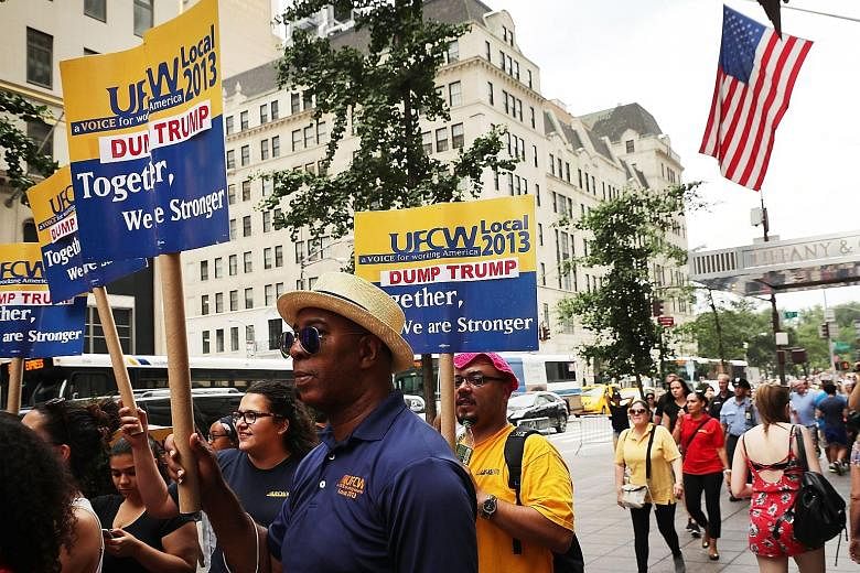 Protesters gathering outside Trump Tower in New York City on Thursday to demand that retailer Walmart rescind its support for the Republican National Committee.